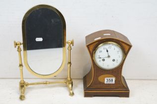 Early 20th C mahogany mantel clock of concave form, with boxwood stringing and shell inlay, with a