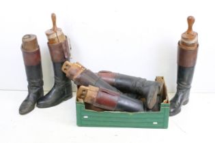 A group of three pairs of vintage leather riding boots complete with wooden trees.