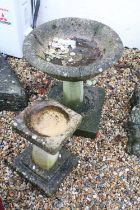 Two reconstituted stone bird baths of classical form, the largest approx 65cm high