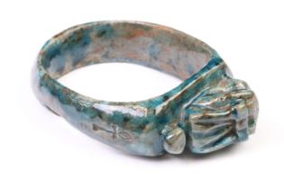 An Egyptian faience bangle with green glaze and Ankh / key of life decoration to sides.