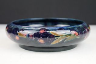 Moorcroft pottery pomegranate pattern round dish having a blue ground with incised and painted