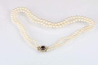 Two strand cultured pearl necklace having graduating pearls with a pink overtone mounted to a