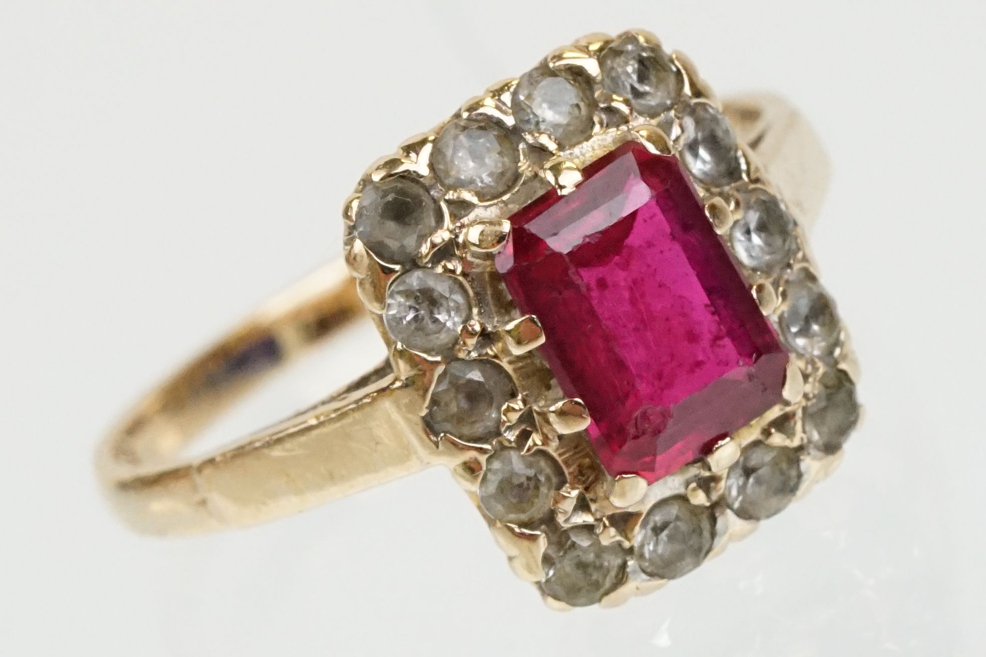 9ct gold hallmarked synthetic ruby and white stone cluster ring. The ring being set with a