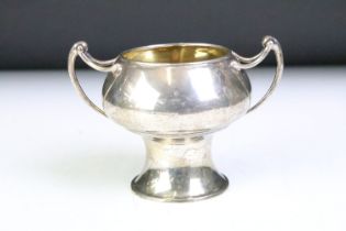 Early 20th Century Edwardian arts and crafts style twin handled cup. The cup having a pedestal