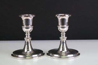 Pair of silver hallmarked candlesticks having round bases, knopped columns and sconces to top.