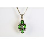 9ct gold pendant necklace being set with four oval cut chrome diopside gemstones with six bezel set