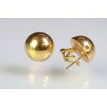 Pair of 18ct gold lever back stud earrings having half dome heads. Marked 750. Measures 1.5cm