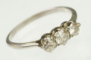 Platinum and diamond three stone ring. The ring being set with three round brilliant cut diamonds in