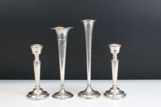 Two silver stem vases together with a pair of silver candlesticks. Both stem vases marked