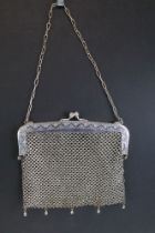 German white metal mesh purse having a hinged clasp to top with scalloped white metal mesh body.