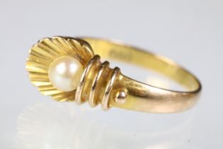 14ct gold and cultured pearl ring having a shell design head with pearl set to the centre. Band