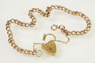 9ct gold heart padlock mounted to a curb link rose metal bracelet. Bracelet hallmarked London