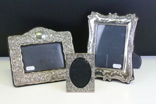 Three photo frames to include a silver fronted frame with bow garland detailing (hallmarked London