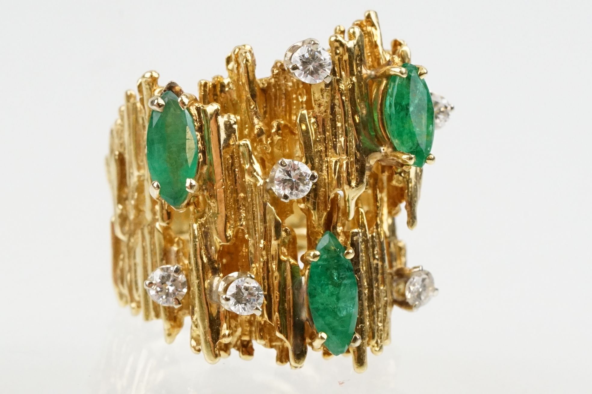 Mid Century emerald and diamond bark effect modernist style ring. The ring having a textured bark