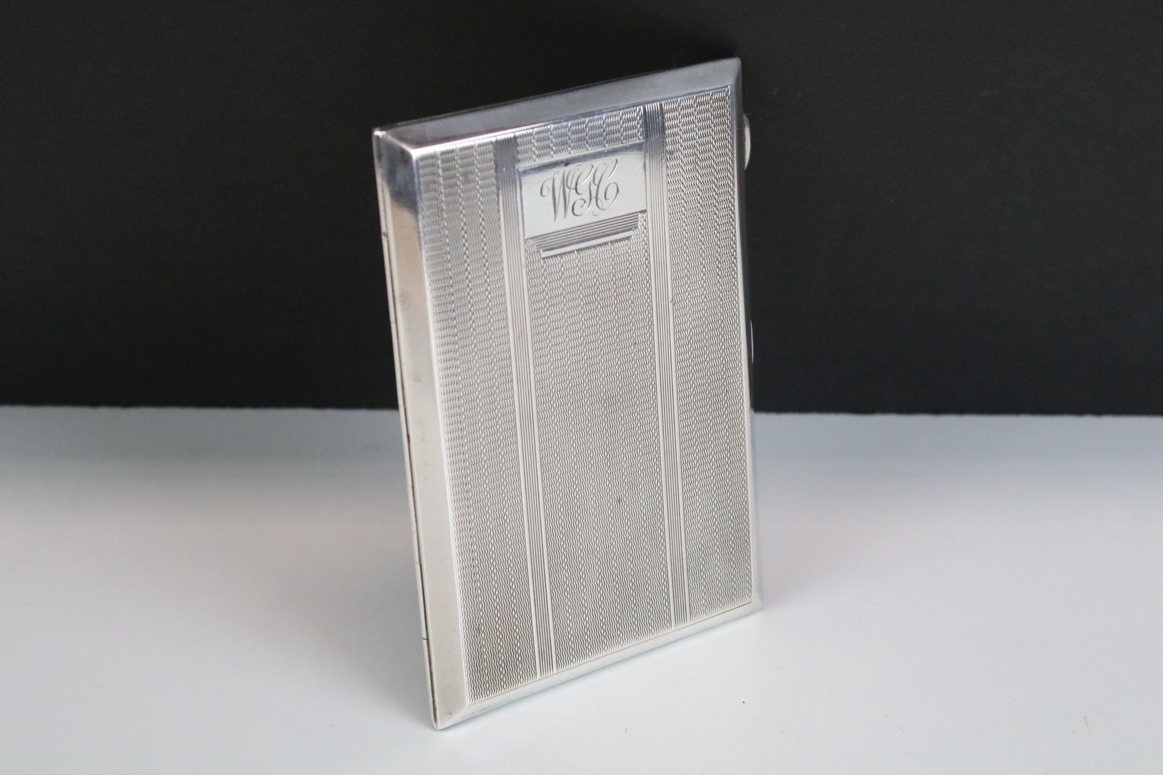 George V silver cigarette case with engine turned decoration, engraved initials, gilt interior,