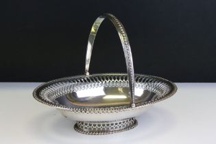 Early 20th Century silver hallmarked footed basket of oval form having a pierced rim with hinged