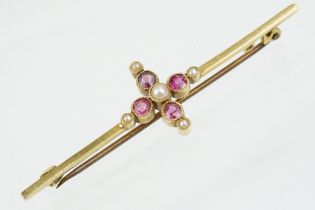 Early 20th Century 15ct gold ruby and pearl bar brooch. The brooch set with four round cut rubies
