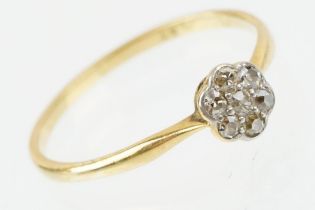 18ct gold and platinum diamond cluster daisy ring. The ring being set with seven single cut