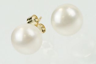 Pair of 9ct gold and cultured pearl stud earrings having spherical pearls with post and butterfly