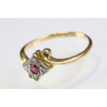 18ct gold ruby and diamond panel ring having a round cut ruby to centre surrounded by four diamond