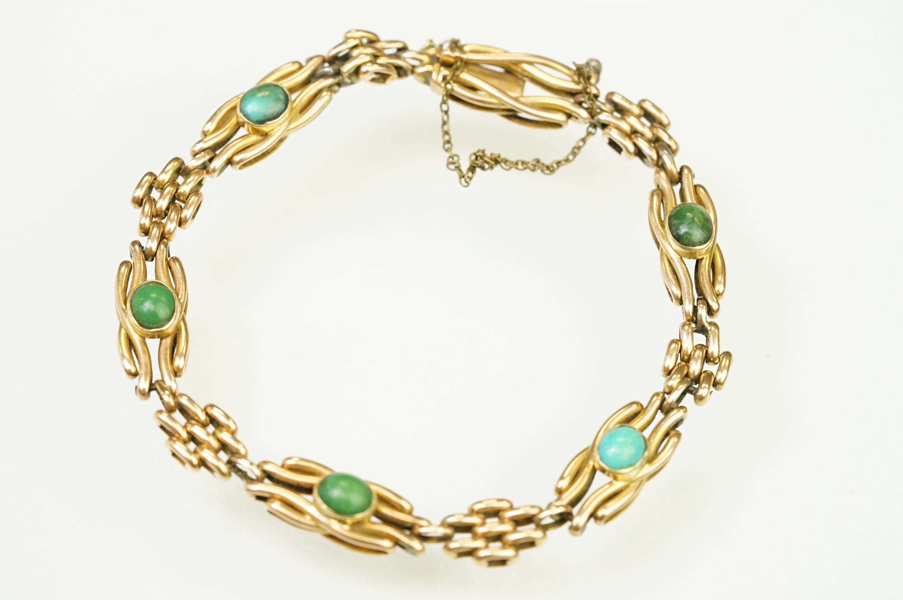 15ct gold and turquoise gate link bracelet. The bracelet being beze set with five oval turquoise