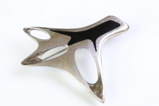 Henning Koppel for Georg Jensen silver and enamel brooch of pierced abstract form with black