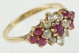 Hallmarked 9ct gold ruby and white stone cluster ring. The ring being set with an oval cut ruby to