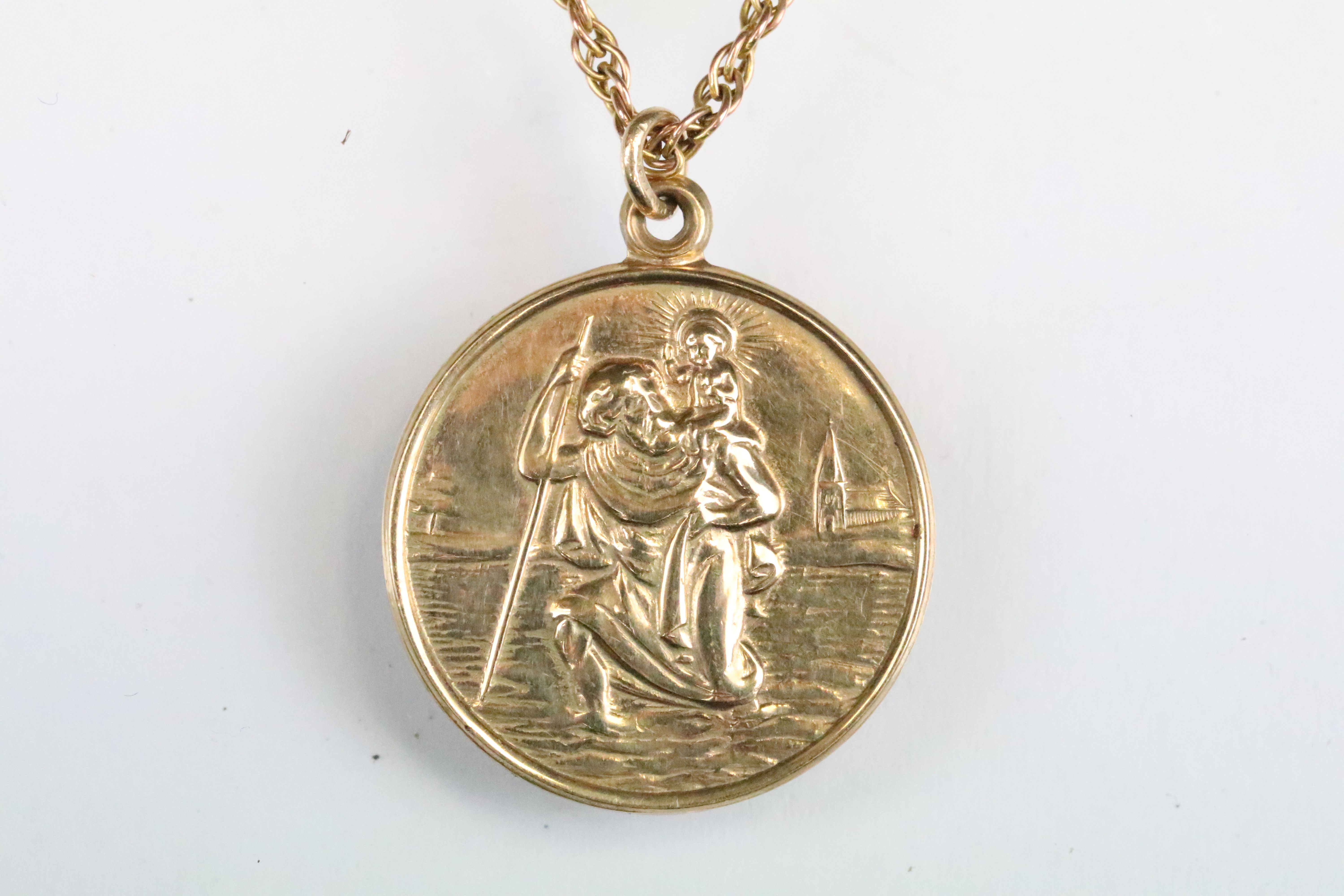 Hallmarked 9ct gold St Christopher pendant of round form mounted to a gold rope twist chain (a/f,
