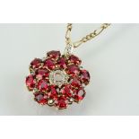 9ct gold ruby and diamond cluster pendant being set with sixteen oval cut rubies around a centre