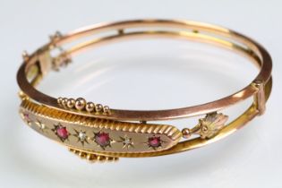 19th Century Victorian 9ct gold, ruby and diamond hinged bangle bracelet. The bracelet consteucted