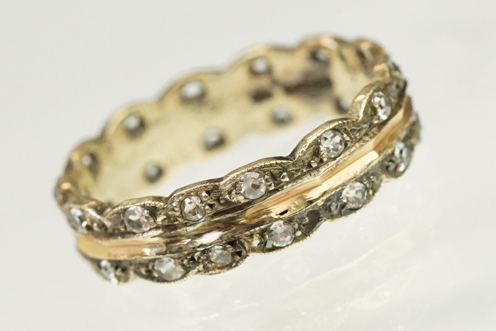 9ct gold hallmarked two tone eternity ring. The ring having a faceted rose gold centre with