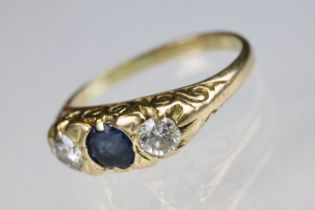 18ct gold sapphire and diamond boat head ring. The ring being set with a round cut sapphire to the