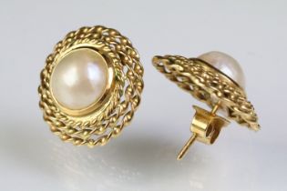 Pair of 18ct gold and cultured pearl stud earrings. Earrings measure 2cm high. Backs marked 750.