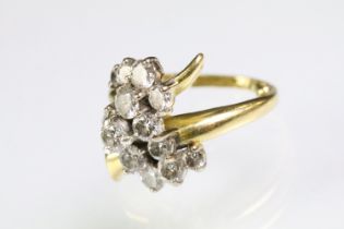 Mid Century Vintage yellow gold and diamond crossover cluster ring being set with fifteen round