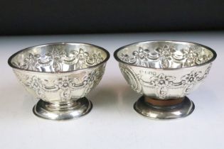 Pair of silver hallmarked footed bowls having moulded floral garlands and unengrved initial