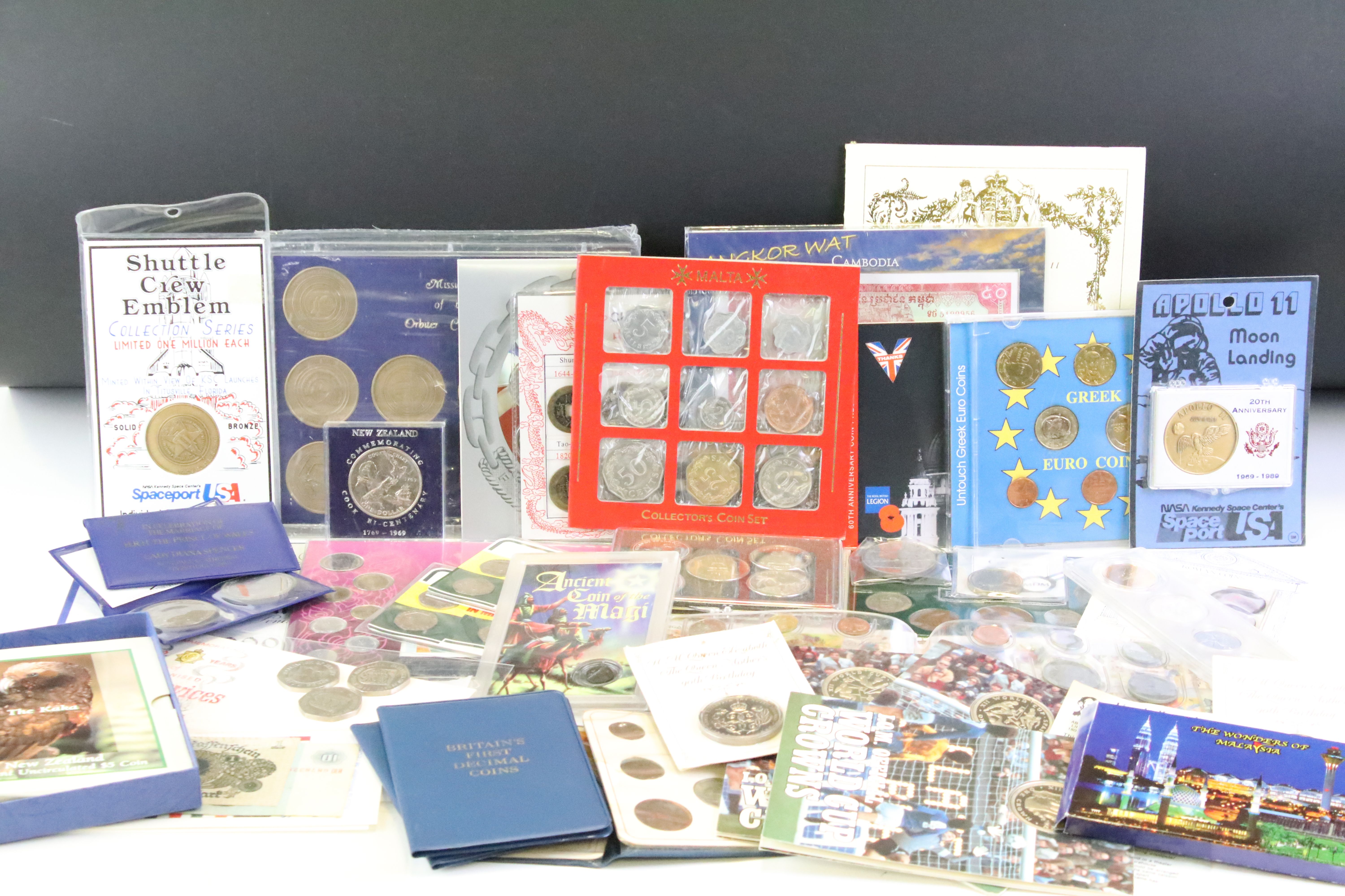 A collection of mixed coins and banknotes to include proof and uncirculated world coin sets, Kenya