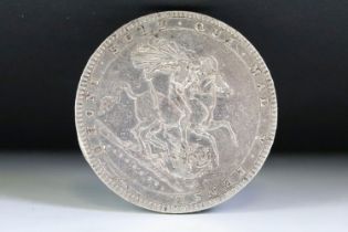 A British King George III early milled 1820 silver full crown coin.