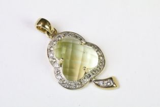 A hallmarked 9ct gold pendant in the form of a three leaf clover, faceted Citrine center stone