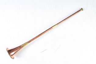 Victorian copper hunting horn having a brass mouth piece and brass banding. Measures 42.5cm.