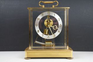 Mid 20th C Kundo electronic skeleton mantel clock, the brass case with four bevelled glass panels,