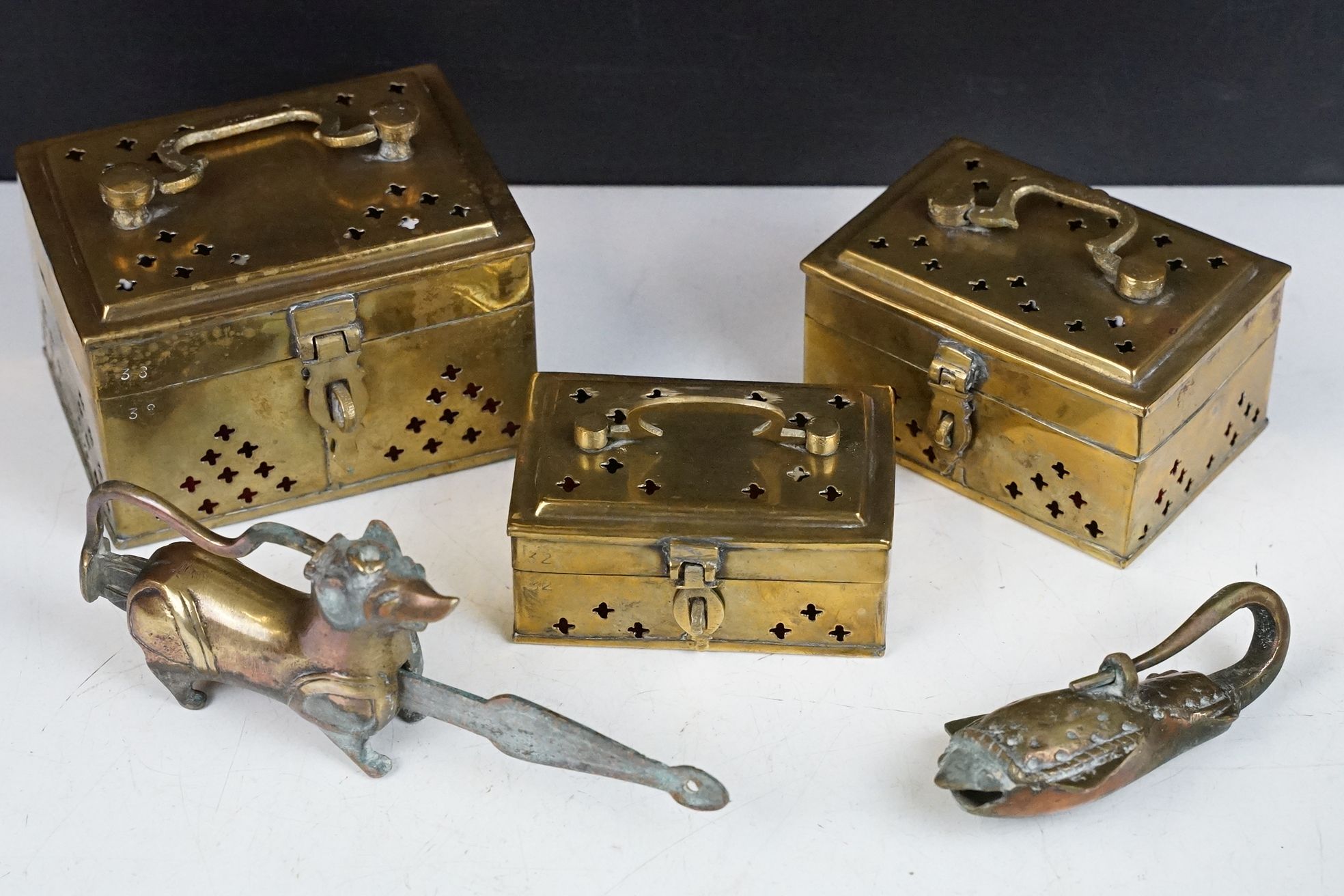 A small group of mixed metal ware to include brass boxes and locks in the form of animals