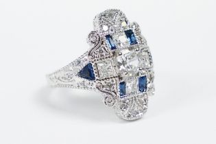 A 925 sterling silver ladies dress ring in the Art Deco style set with blue and clear stones, marked