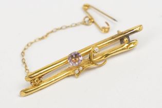 A vintage ladies 9ct gold bar brooch set with amethyst and seed pearls, complete with safety