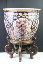 Large Chinese fish bowl planter, decorated in the Imari palette, with panels depicting flowers