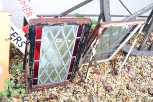 Pair of leaded stained glass windows, within wrought iron frames, measure approx 59cm x 40cm