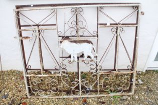 Pair of wrought iron drive gates with lion details, each gate measures approx 134cm in width