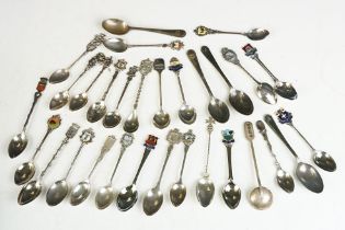 A collection of sterling silver and silver plated souvenir teaspoons.