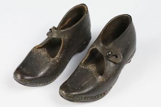 A pair of antique childrens leather shoes.