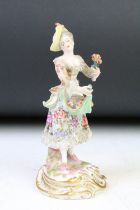 Continental porcelain figurine of a female holding flowers, with hand painted floral decoration,