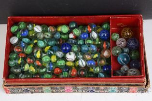 A box of mixed marbles of various sizes and colours.